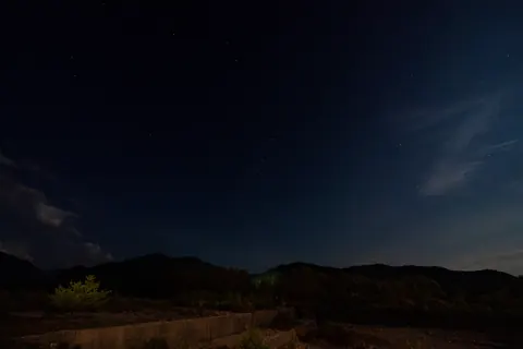 暗い稜線の上に広がる星空